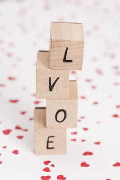 The word love misspelled, constructed out ouf wooden blocks.