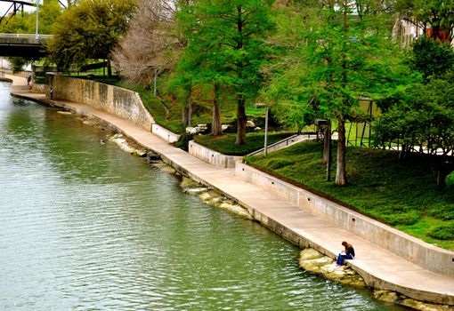 Waco woman reads on bank of river