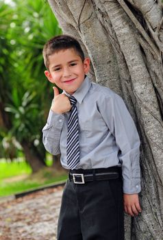 Portrait of attractive young child with thumbs up