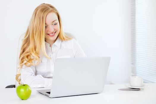 happy business woman with laptop in office