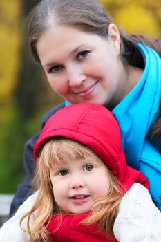 beautiful little girl and mother in autumn park