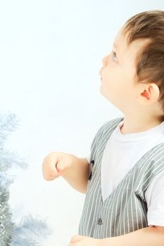 beautiful happy small kid decorate christmas tree