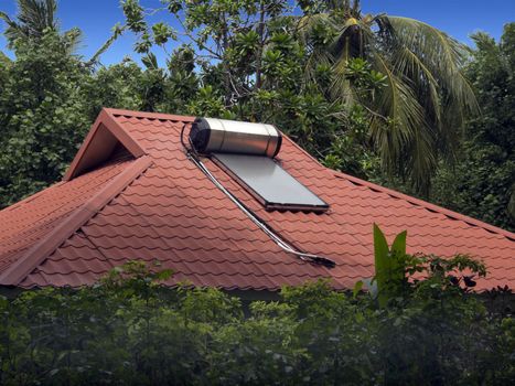 Solar water heater sits on the roof of a home in the Maldive islands