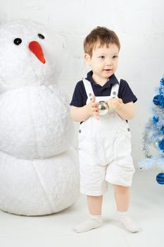 beautiful happy small kid decorate christmas tree