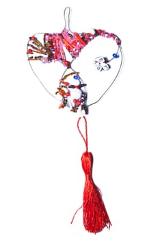 Decorative heart from colorful beads on a white background.