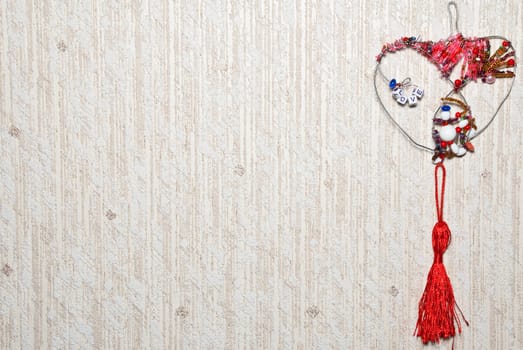 Decorative heart from colorful beads on a textured background.