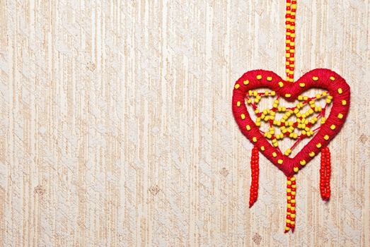 Red heart of colored beads with copy space.
