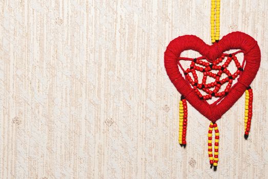 Red heart of colored beads with copy space.