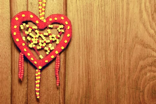 Red heart on the old wood background.