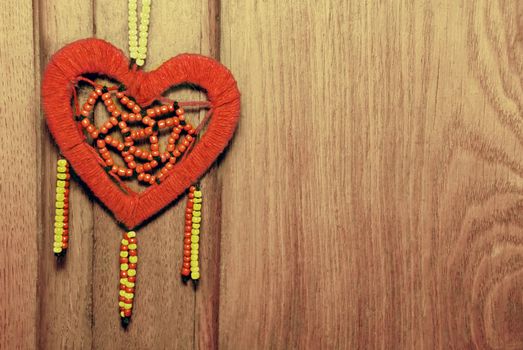 Red heart on the old wood background.