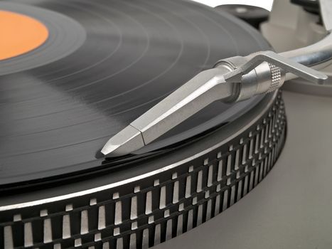 record playing on turntable and cartridge in front view