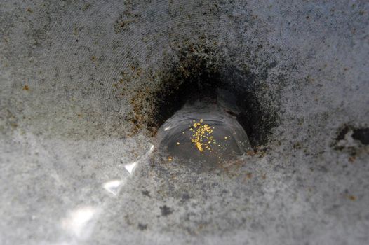gold spangles of river at the bottom of a jamb                               