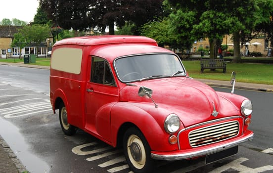 Old red vintage pickup automobile in country town