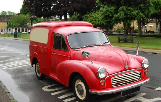 Old red vintage pickup automobile in country town