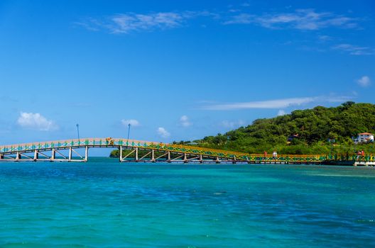 Colorful bridge connecting two lush tropical islands in San Andres y Providencia, Colombia
