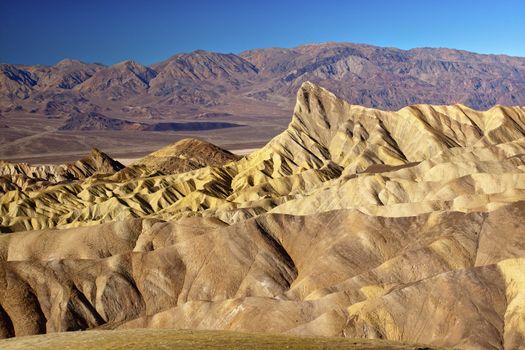 Zabriski Point Manly Beacon Mudstones form Badlands  Death Valley National Park California