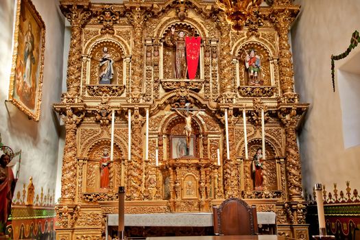 Spanish Ornate Golden Altar Serra Chapel Mission San Juan Capistrano Church in California.  Father Junipero Serra founded the Mission in 1775, and the altar is 300 years old from Barcelona, Spain.