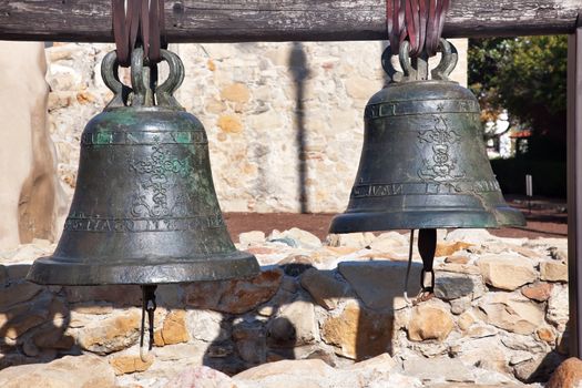 Old Brass Bells Mission San Juan Capistrano Churchand Ruins in California.  The church was destroyed in 1812 by earthquake and these are the old bells recovered from the ruins.