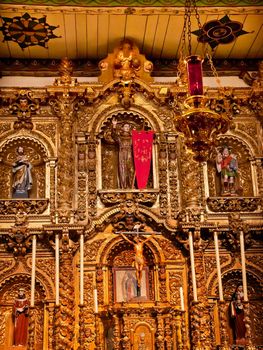 Spanish Ornate Golden Altar Serra Chapel Mission San Juan Capistrano Church in California.  Father Junipero Serra founded the Mission in 1775, and the altar is 300 years old from Barcelona, Spain.