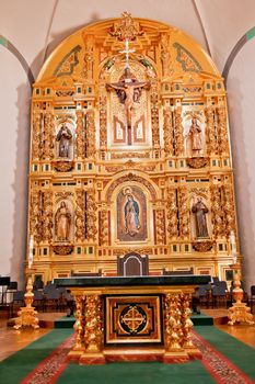 Golden Altar at Mission Basilica San Juan Capistrano Church California.  This is the successor church to the Mission founded by Father Junipero Serra in 1775.