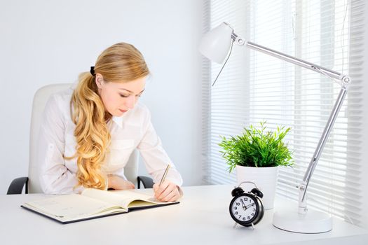 portrait of smiling office girl working at desk