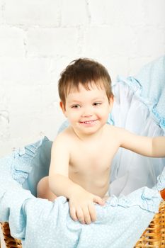 funny boy in cradle, happy and smiling