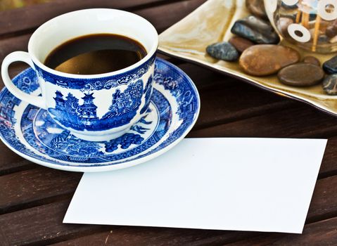 Cup of coffe on the table with a note 