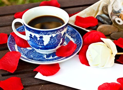 Cup of coffe on the table with a note 