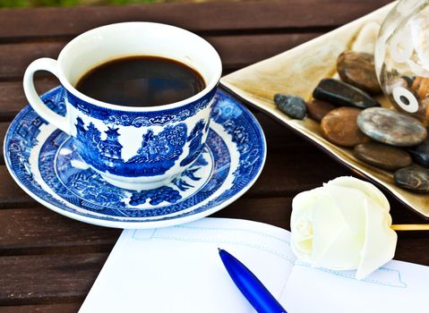 Cup of coffe on the table with a note 