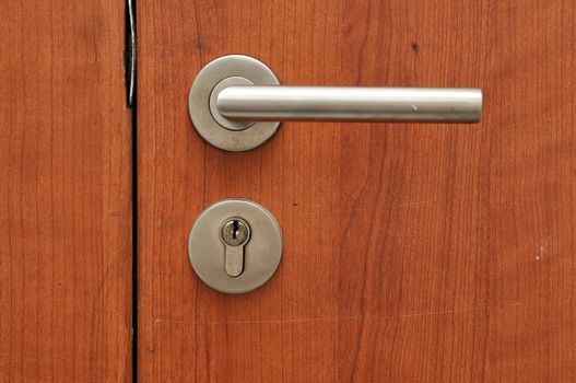 Modren style door handle on natural wooden door