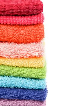 Frame of Stacked Rainbow Colored Towels closeup on white background