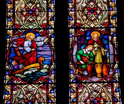 Jesus Quieting Water Making Wine Stained Glass in National Shrine of Saint Francis of Assisi San Francisco California.  This church was founded in 1849 and rededicated in 1919 after church was destroyed in 1905 earthquake.