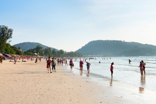 PHUKET, THAILAND - Jan 28: Crowded Patong beach with tourists on Jan 28, 2013 in Phuket, Thailand. Phuket is a famous winter destination for thousands of tourists. 