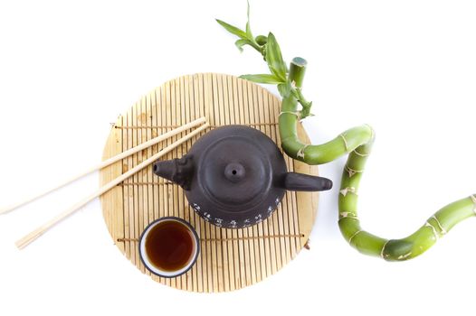 tea set and a branch of bamboo