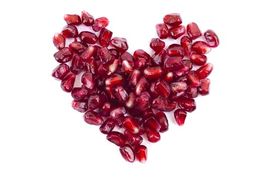 pomegranate seeds in heart shape isolated