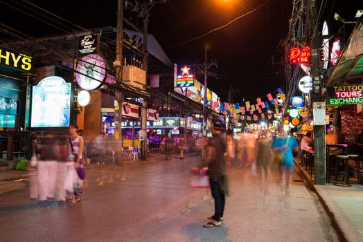 PHUKET, THAILAND - Jan 28: Patong Bangla road with blurred tourists and barkers at night on Jan 28, 2013 in Phuket, Thailand. Bangla road is a famous tourists place with bars and discos. 