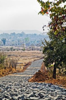 Vertical capture of road building in rural Maharashtra, India in the valley of the Sahyadhri mountains where life has been for centuries, without electrical power or running water is about to change with the arrival of infrastructure and roads