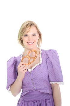 Portrait of a blond german girl, wearing a lavender dirndl dress and holding a bretzel. On white