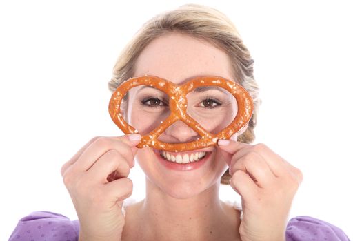 Smiling girl , holding a bretzel to her face like reading glasses