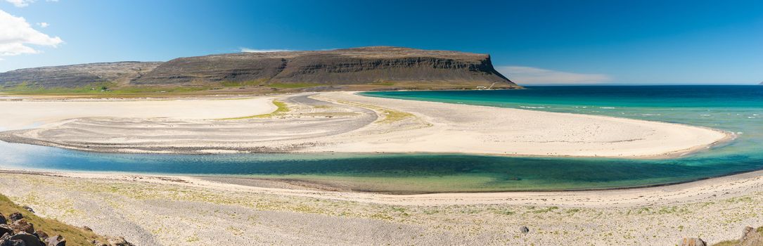 Extremly beautiful bay with mighty golden beaches and turquise sea in the West Fjords, Iceland. Panoramic photo