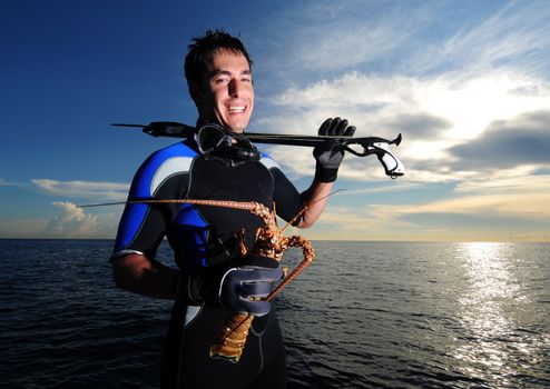 Young man ready for spearfishing with speargun in the Bahamas