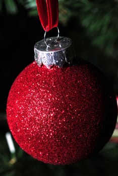 close up of a red glitter ornament for christmas