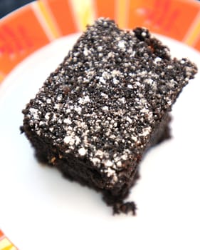 brownie or chocolate cake with powdered sugar as a topping