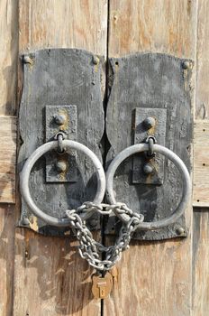 lock and chains on rustic old wooden door