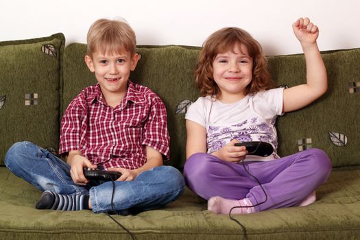 little girl and boy play video game