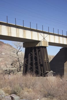 An old train bridge crossing teh truckee river in western nevada