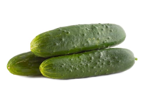 Three green cucumbers close-up, isolated on white background.