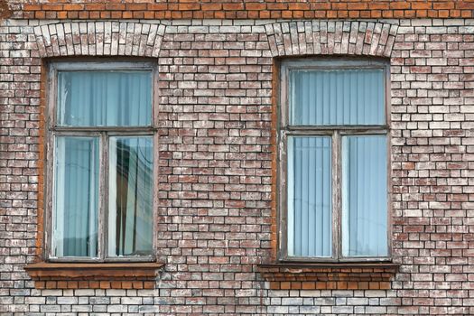 View of two closed windows with pattern on wall of ancient buildings, Russia.