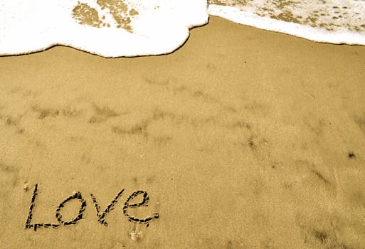 Love written in the sand with wave 26