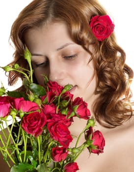 nice girl smelling roses on a white background isolated